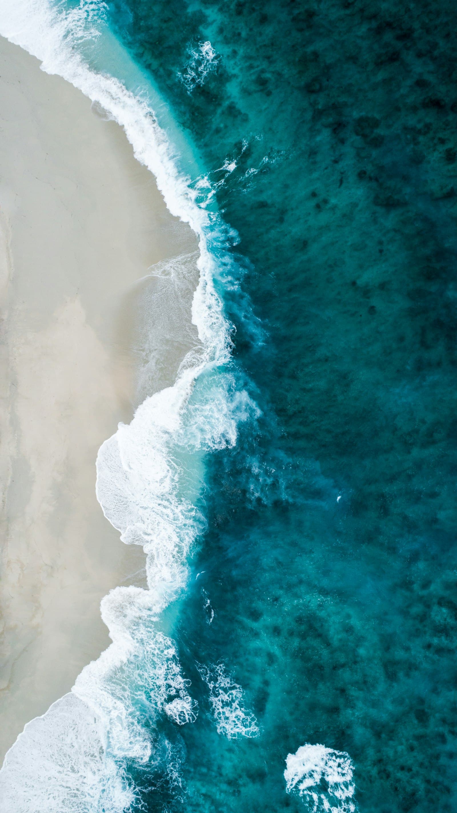 Calm Atlantic shoreline at dusk with gentle surf and soft horizon light.